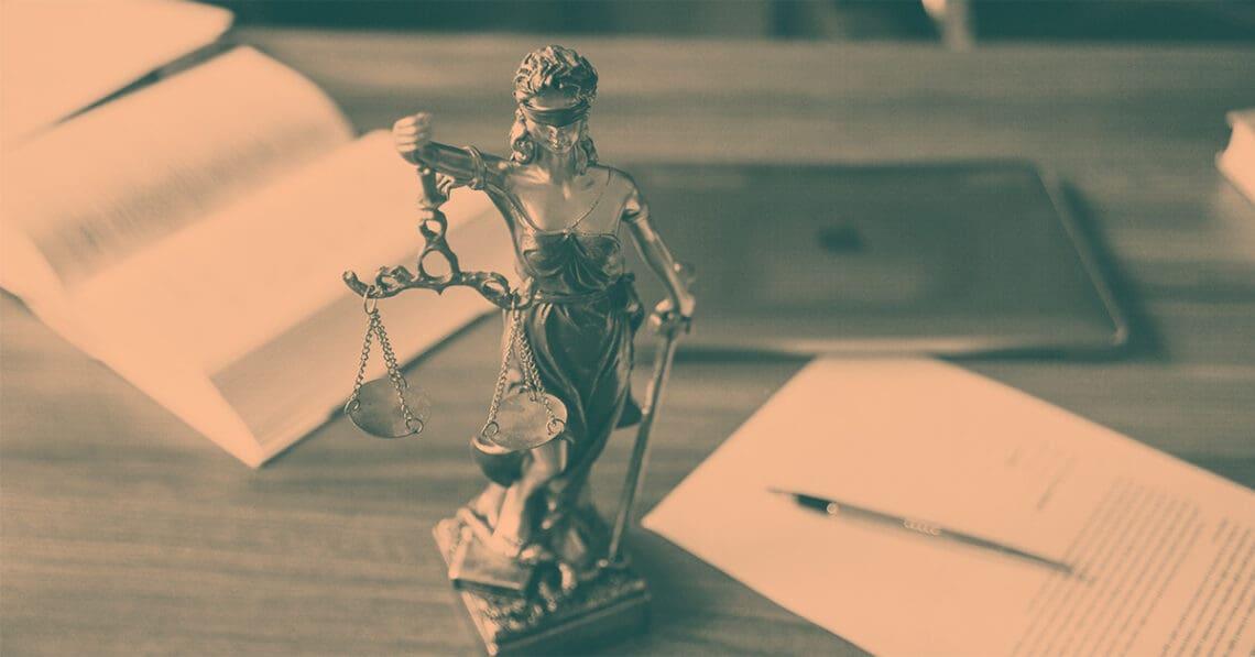 scales of justice statue on desk
