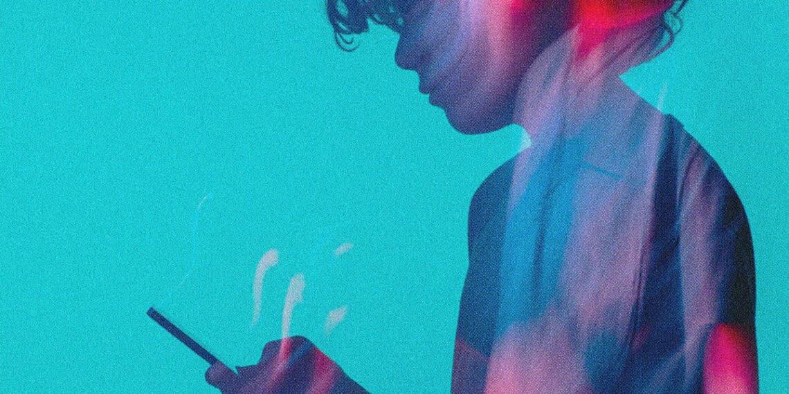 teen looking at smartphone