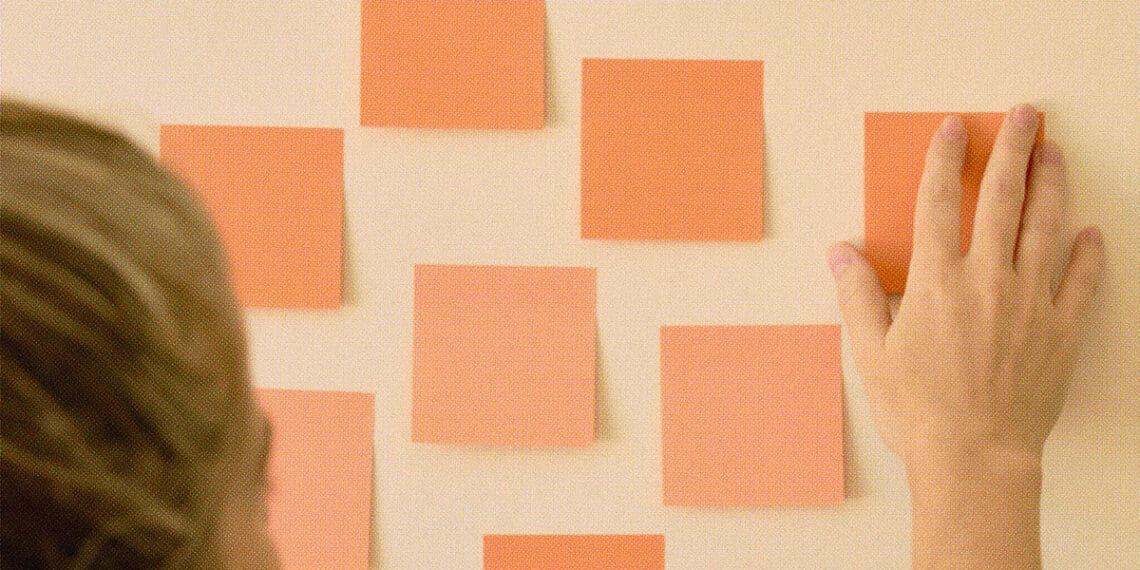 woman setting intentions on post it notes