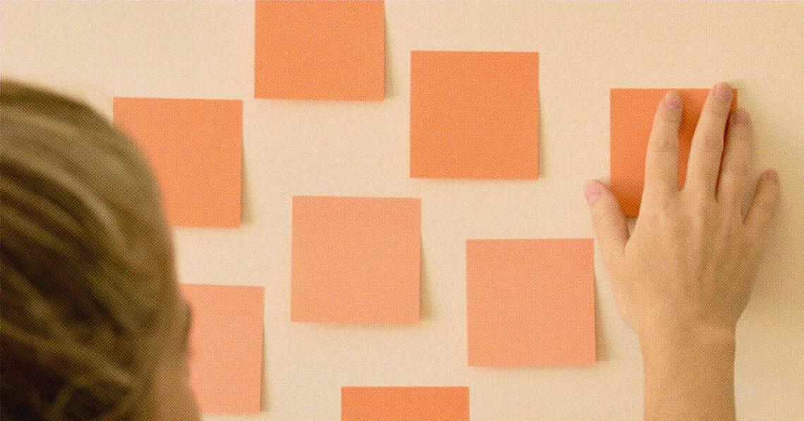 woman setting intentions on post it notes