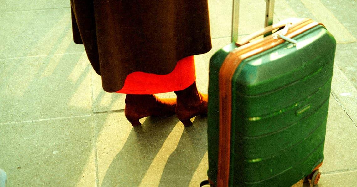 woman traveling for work with suitcase