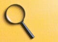 magnifying glass on yellow background