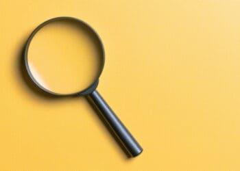 magnifying glass on yellow background