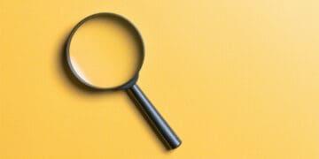 magnifying glass on yellow background