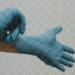 person putting on surgical latex gloves