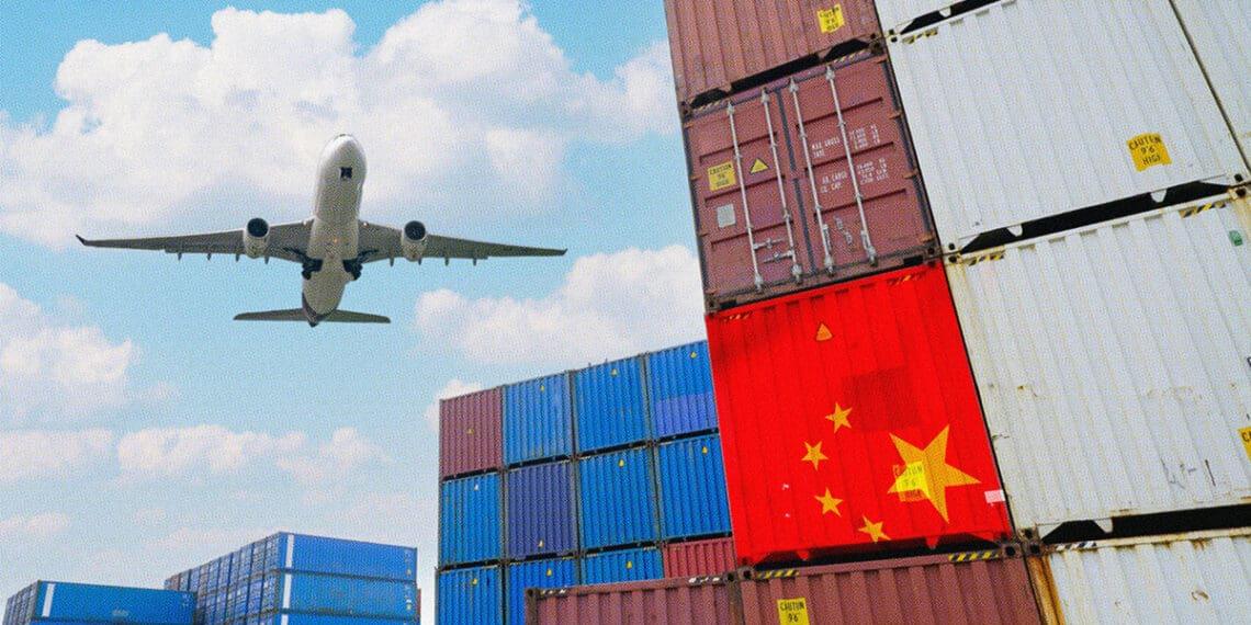 airplane flying over cargo containers