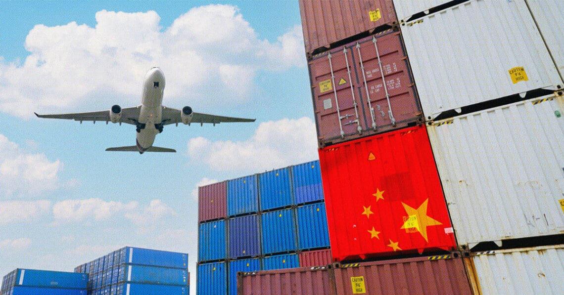 airplane flying over cargo containers