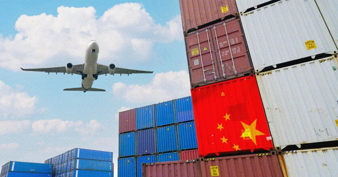 airplane flying over cargo containers