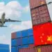 airplane flying over cargo containers