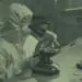 lab technician looking at sample in microscope