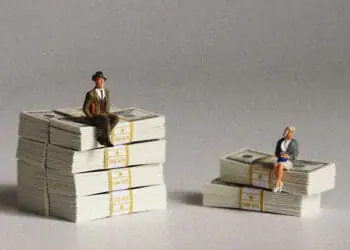 large bank small bank concept figurines and stacks of cash