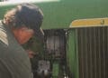 mechanic working on john deere tractor