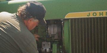 mechanic working on john deere tractor