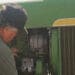 mechanic working on john deere tractor