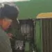 mechanic working on john deere tractor
