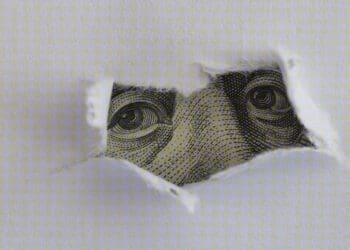dollar obscured by torn paper