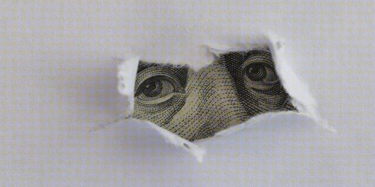 dollar obscured by torn paper