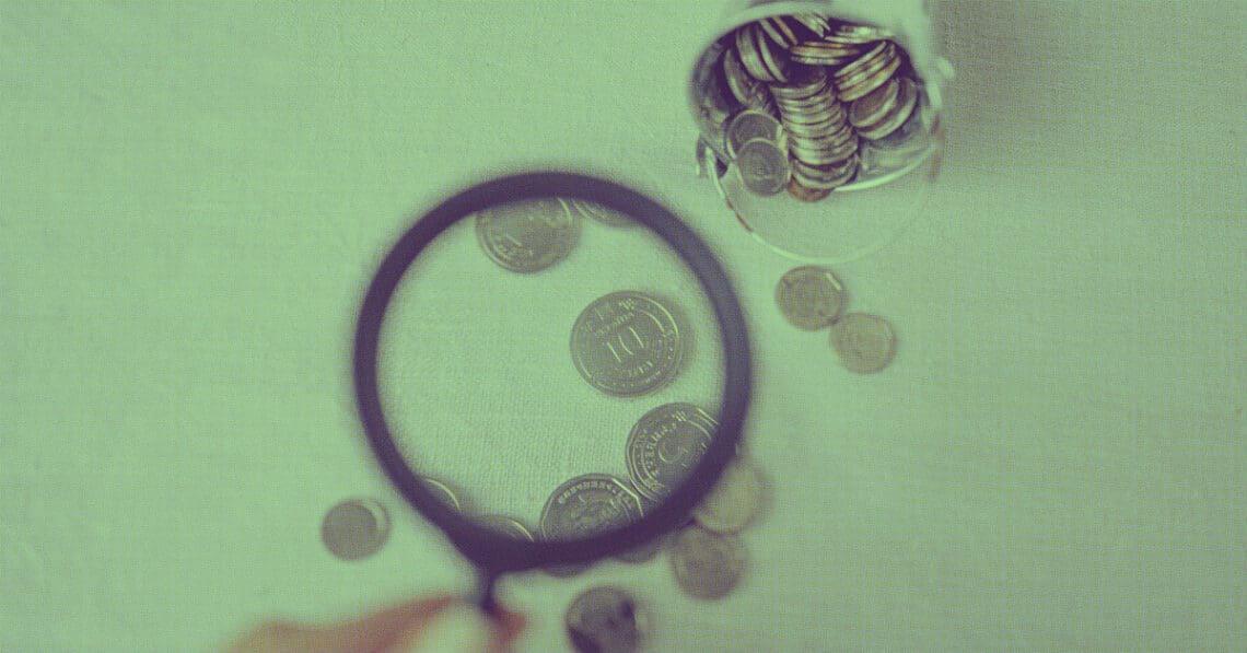 examining financial data with magnifying glass