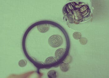 examining financial data with magnifying glass