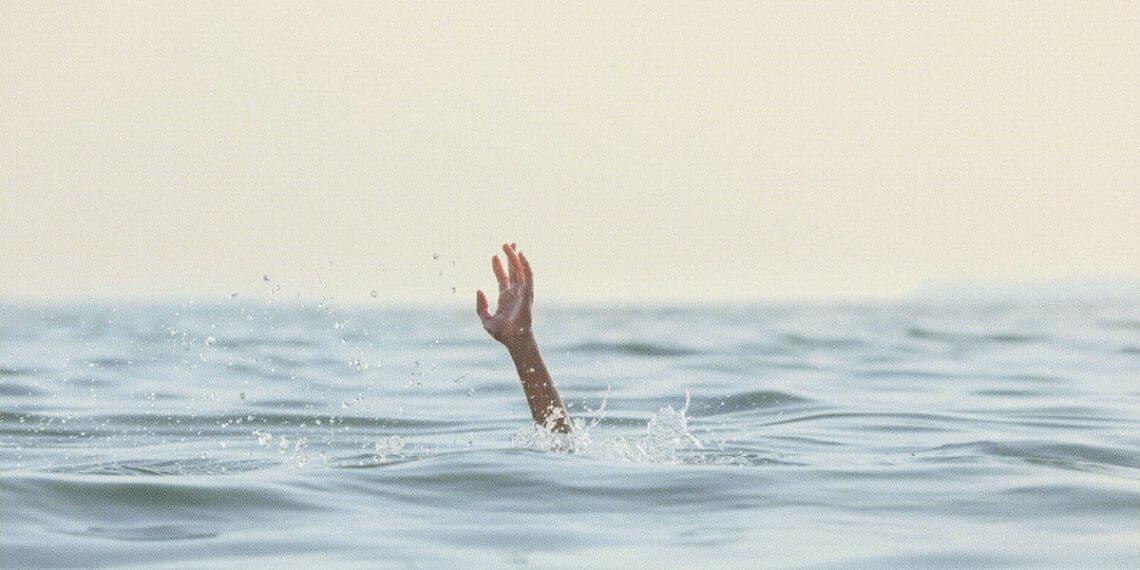 person reaching for help in sea