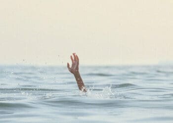 person reaching for help in sea
