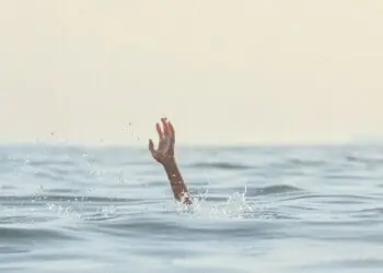person reaching for help in sea