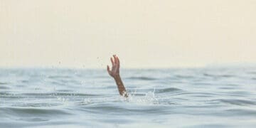 person reaching for help in sea