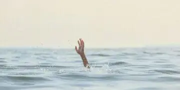 person reaching for help in sea
