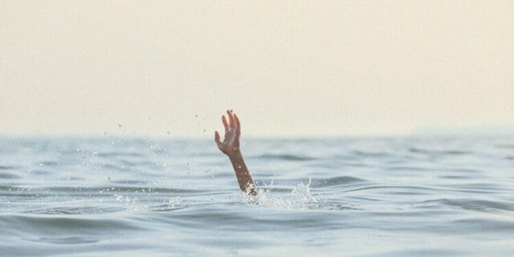 person reaching for help in sea