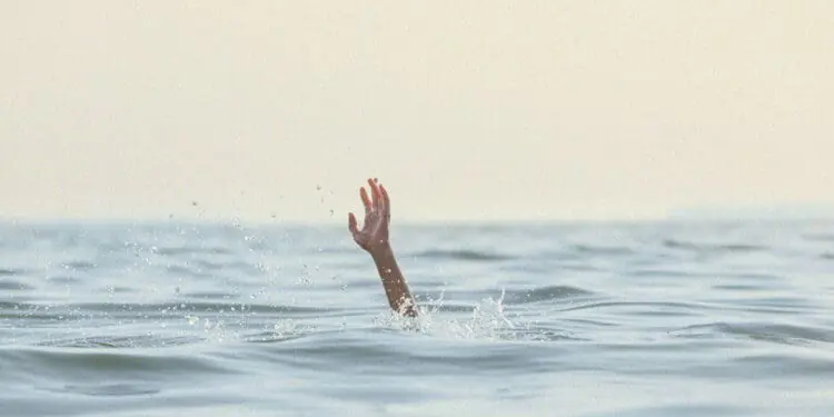 person reaching for help in sea