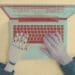 computer and human arms at laptop