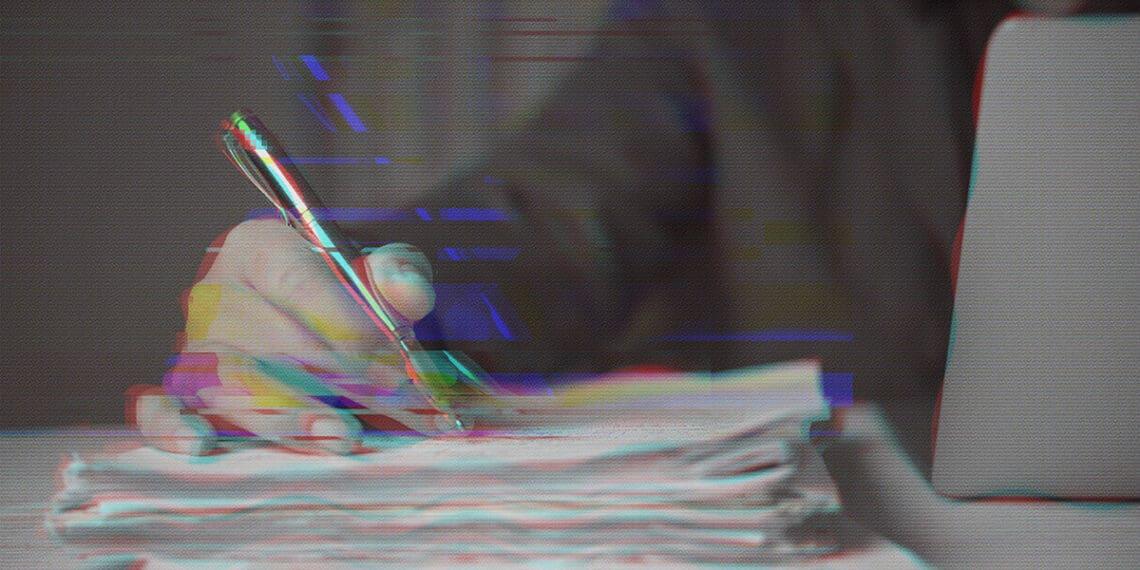 hand on pile of papers