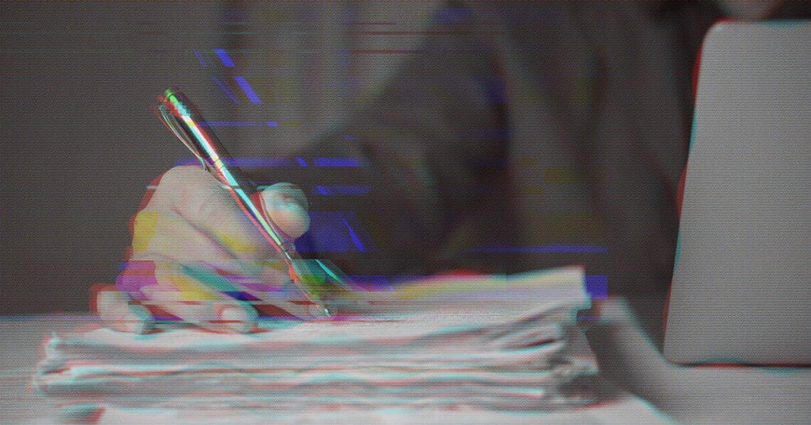 hand on pile of papers