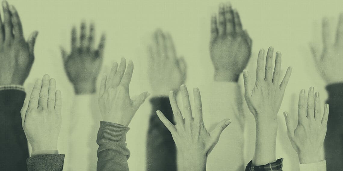 hands raised at meeting