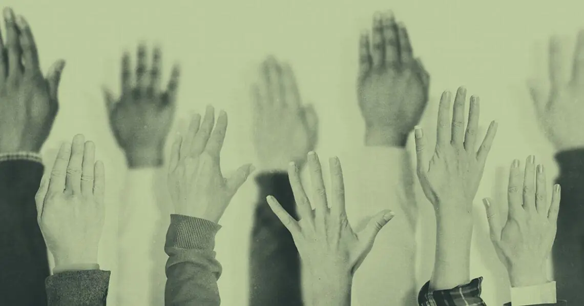hands raised at meeting