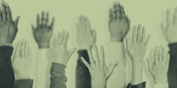 hands raised at meeting