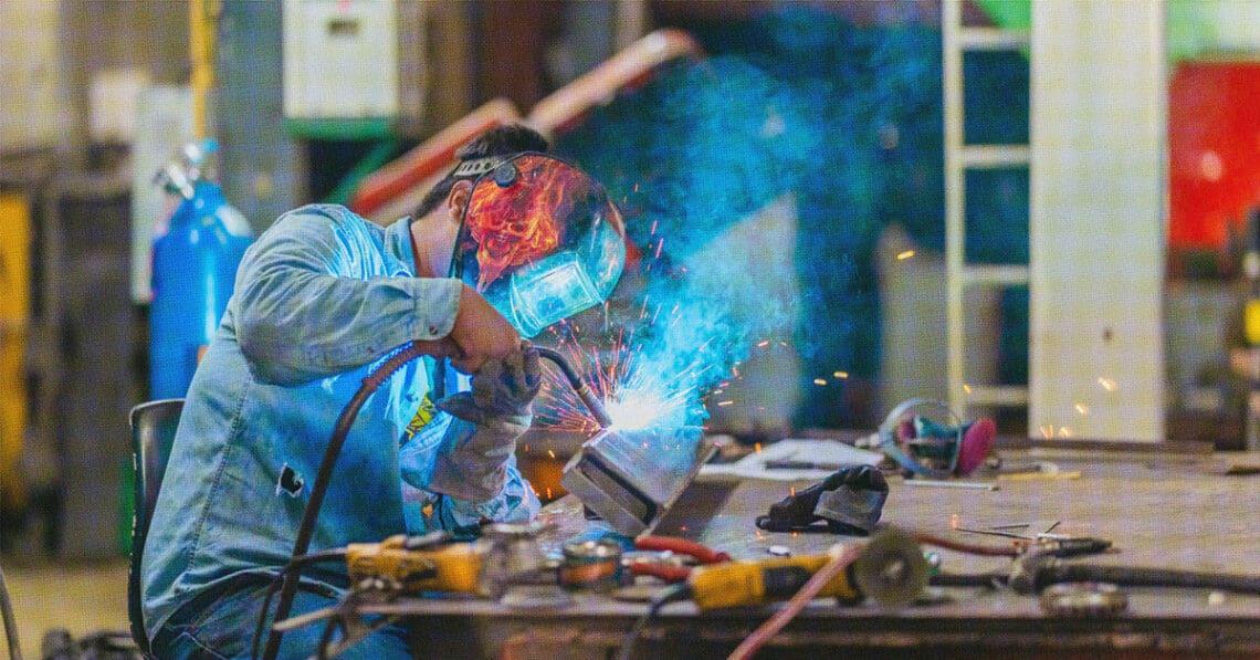 man welding in shop