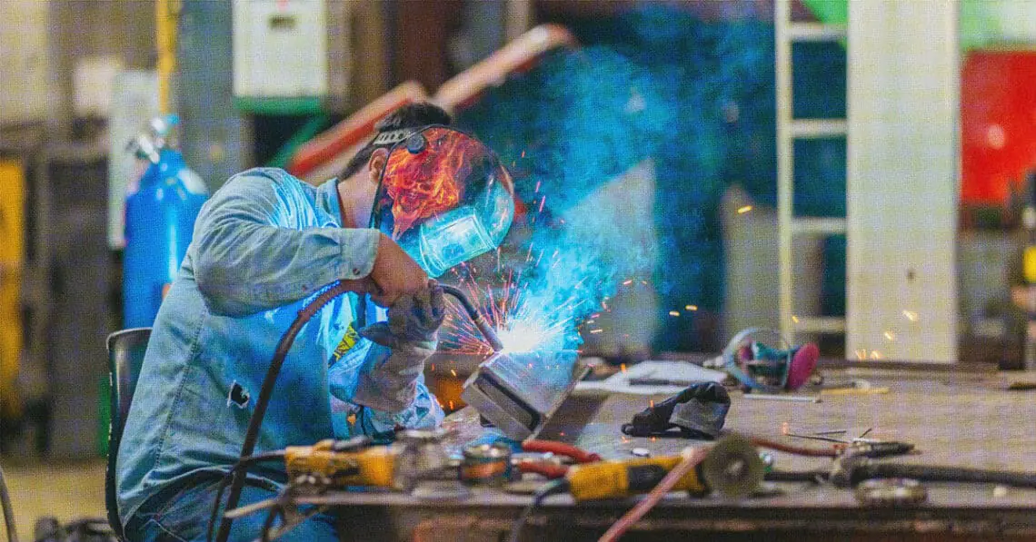 man welding in shop