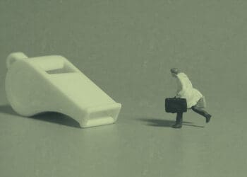 whistleblower concept figurine chasing whistle