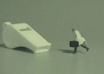 whistleblower concept figurine chasing whistle