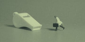 whistleblower concept figurine chasing whistle