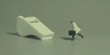 whistleblower concept figurine chasing whistle