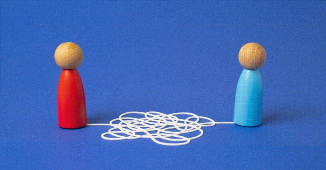 common language wooden block people string attached